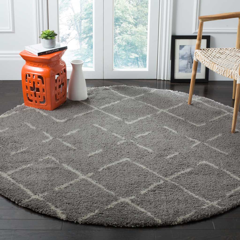 An oversized ivory diamond lattice brightens the soft gray surface of this round rug