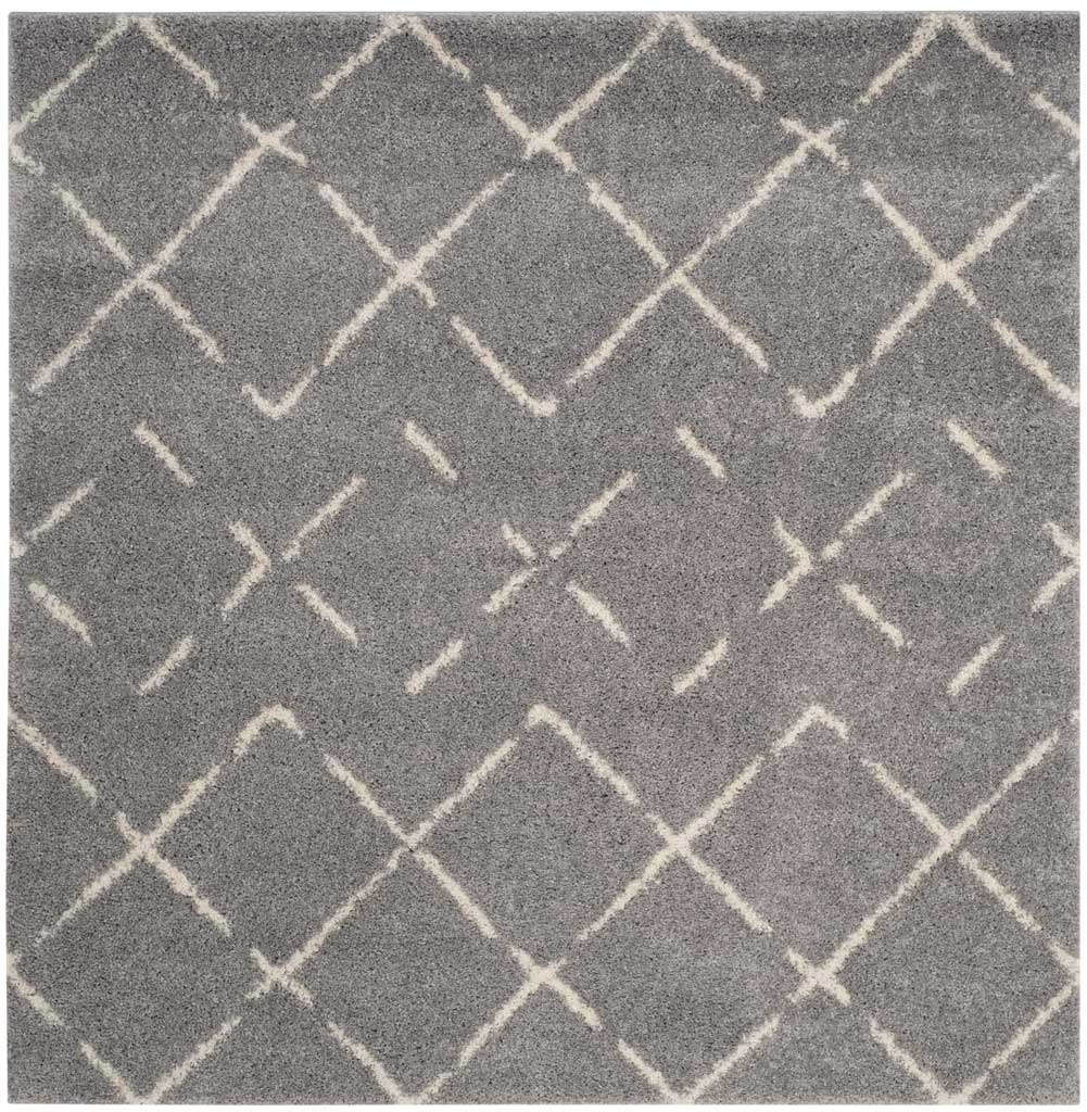 Square smoky gray rug layers irregular ivory lattice lines over a plush surface.