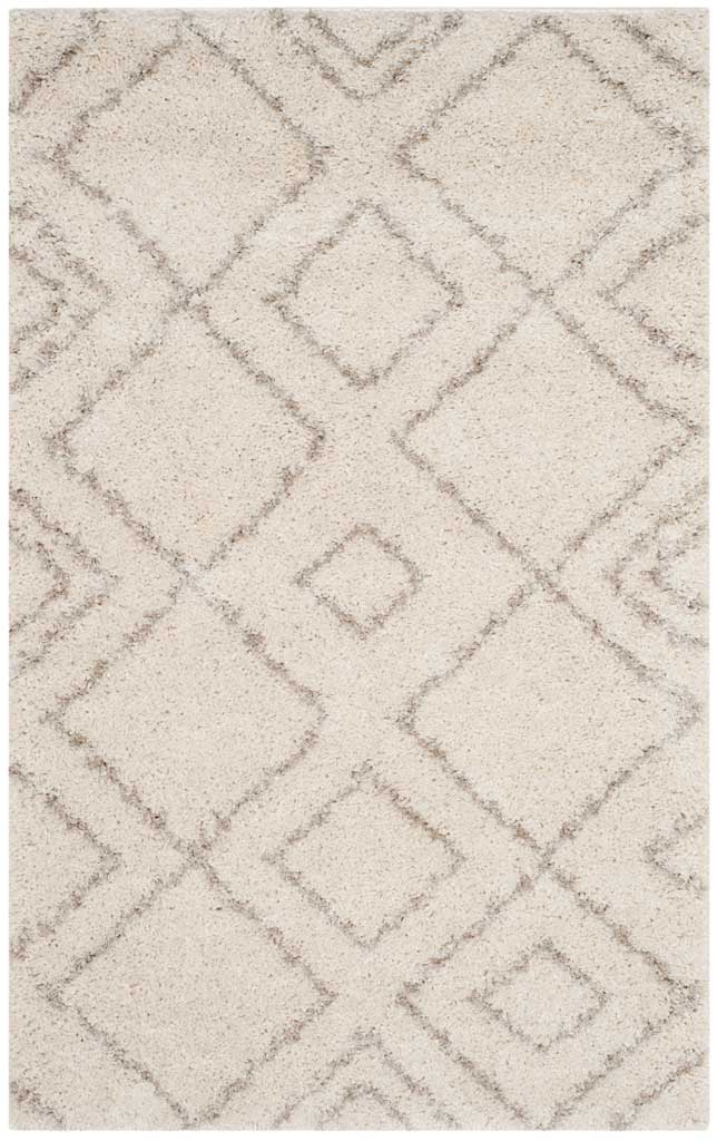 Compact ivory and beige shag rug layers large diamond outlines with smaller accents.