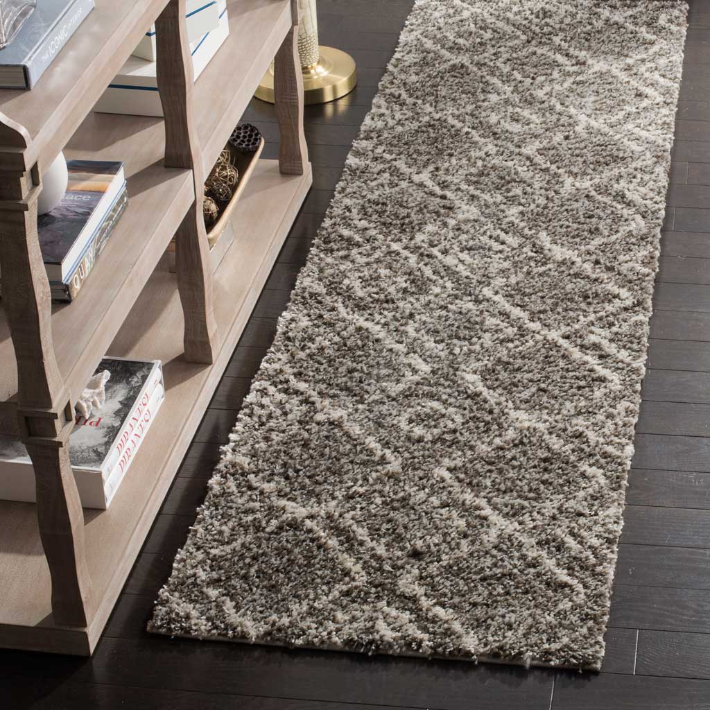 Thick brown and ivory shag fibers lend soft dimension to this geometric runner.
