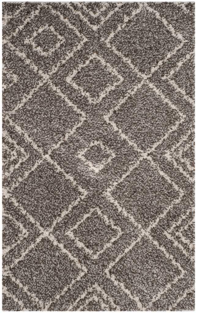 Compact brown and ivory rug with bold interlocking diamonds and a thick, cozy pile.