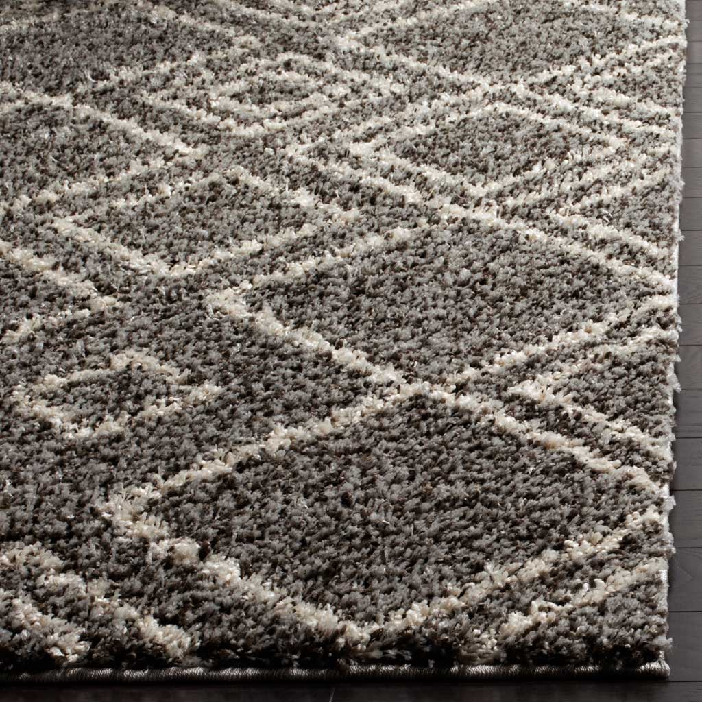 Dense brown shag and ivory diamond lines meet at a neatly finished rug edge.
