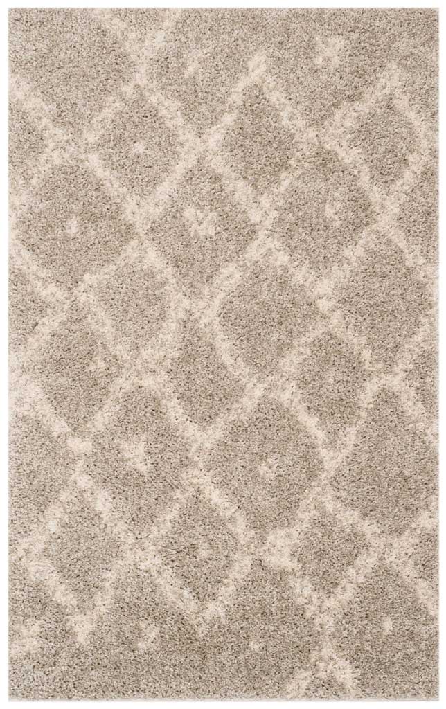 Small gray shag rug carries a loose ivory diamond trellis across its deep pile.
