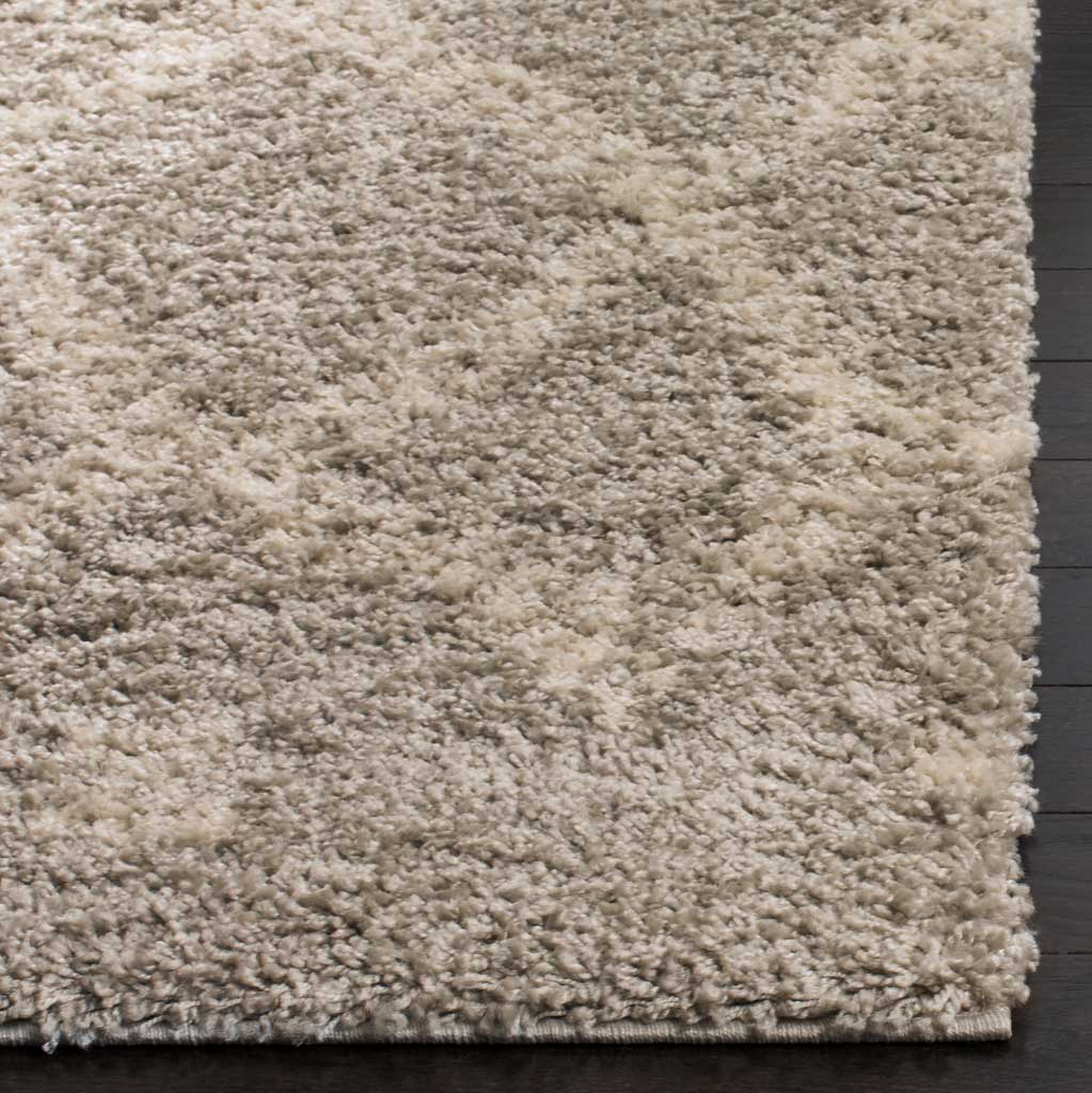 Fluffy gray and ivory fibers add texture and depth to the rug's finished corner.