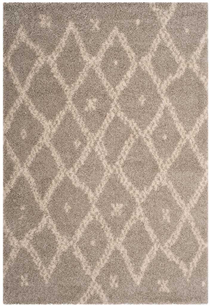 Plush gray area rug features broken ivory diamond lines and scattered light flecks.