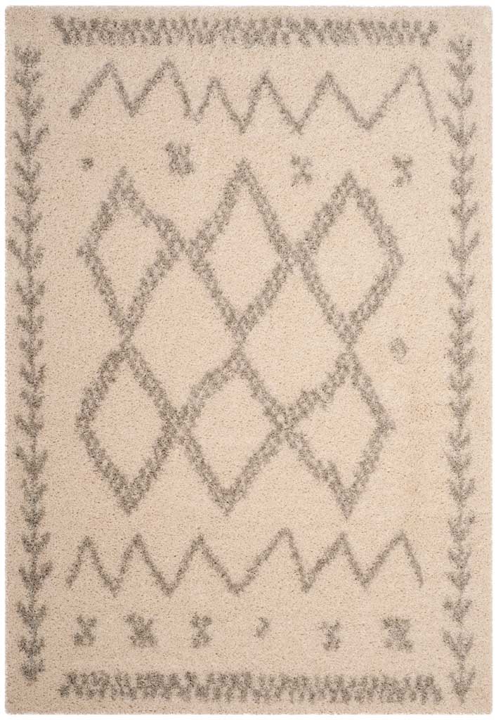 Ivory shag rug features gray diamonds, zigzag bands, and fine botanical side motifs.
