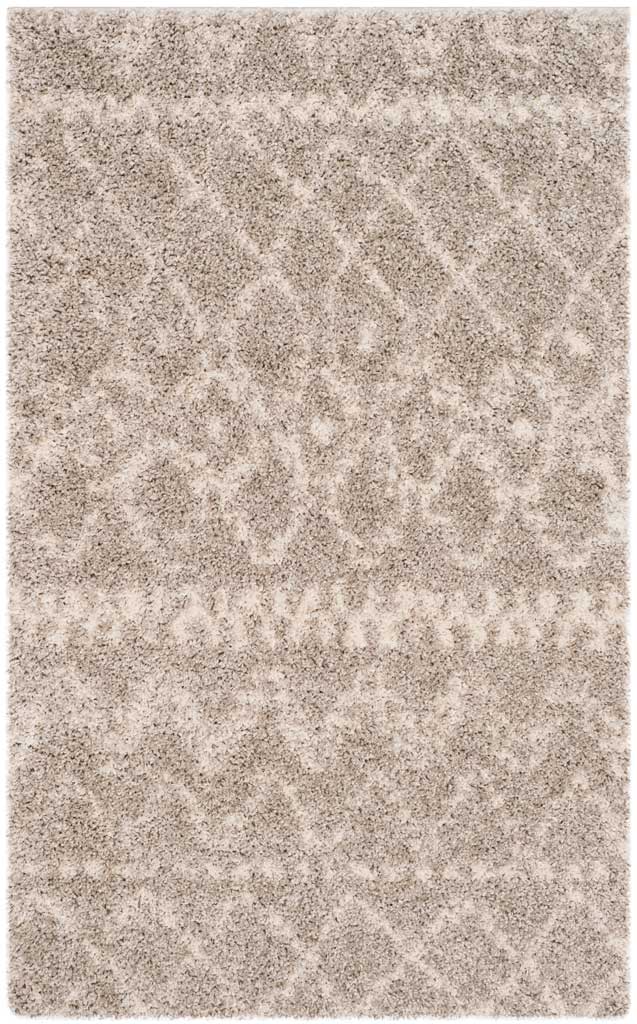 Compact gray rug shows delicate ivory motifs and diamond lines over plush shag.