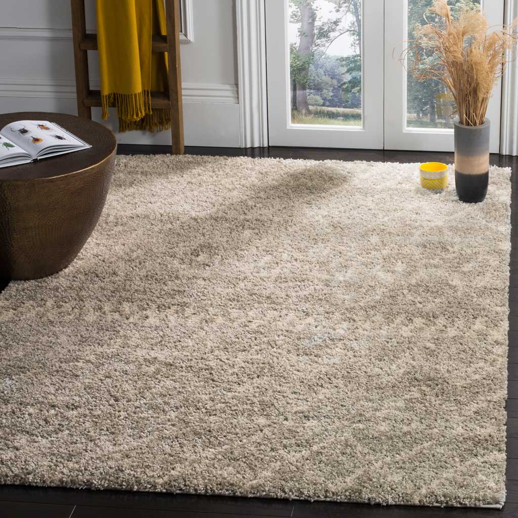 Gray and ivory shag with subtle geometric motifs lends cozy texture beside a low table.