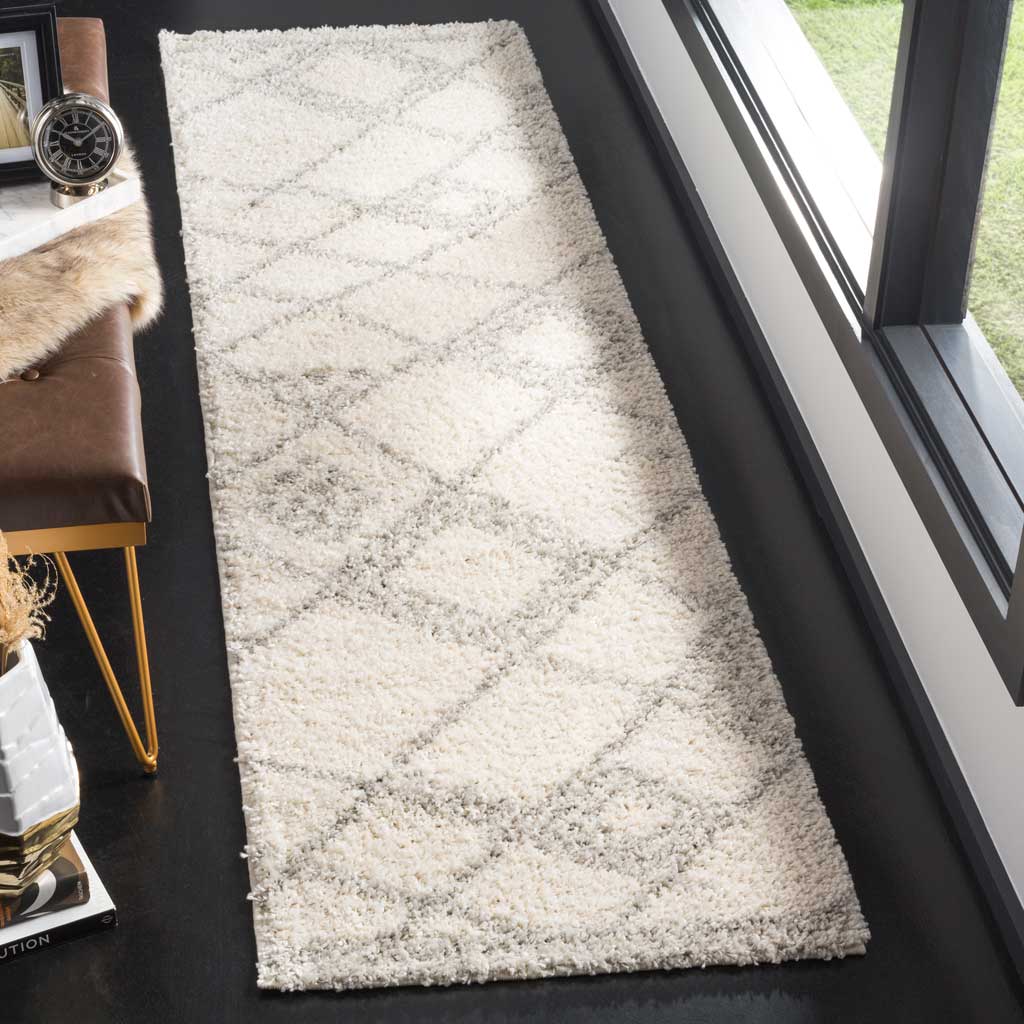 A plush ivory pile sets off soft gray crisscross accents on this runner.
