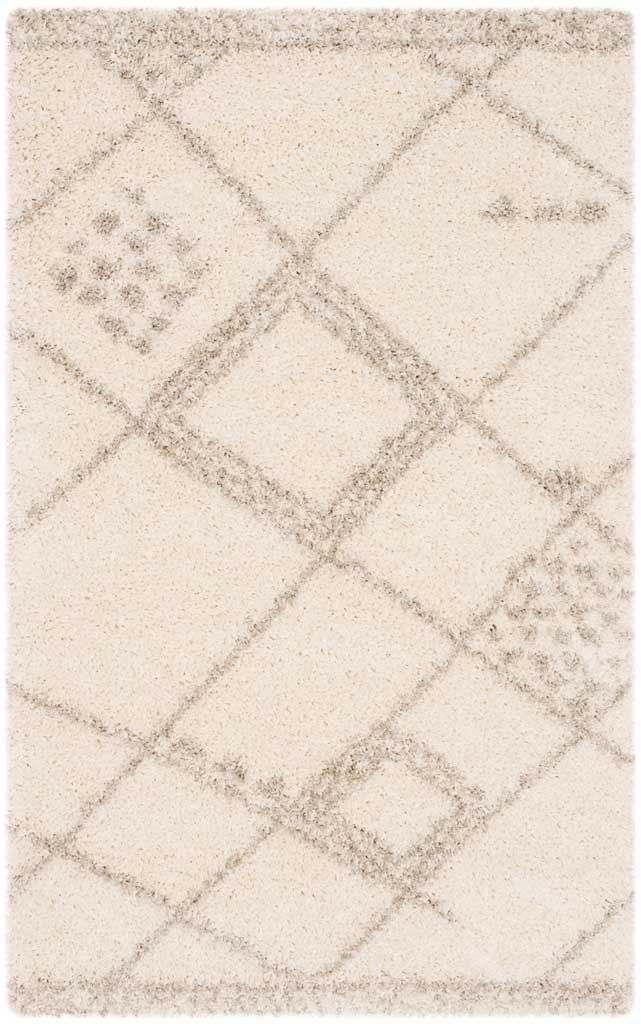 Small ivory shag rug features oversized gray lattice lines and delicate dotted motifs.