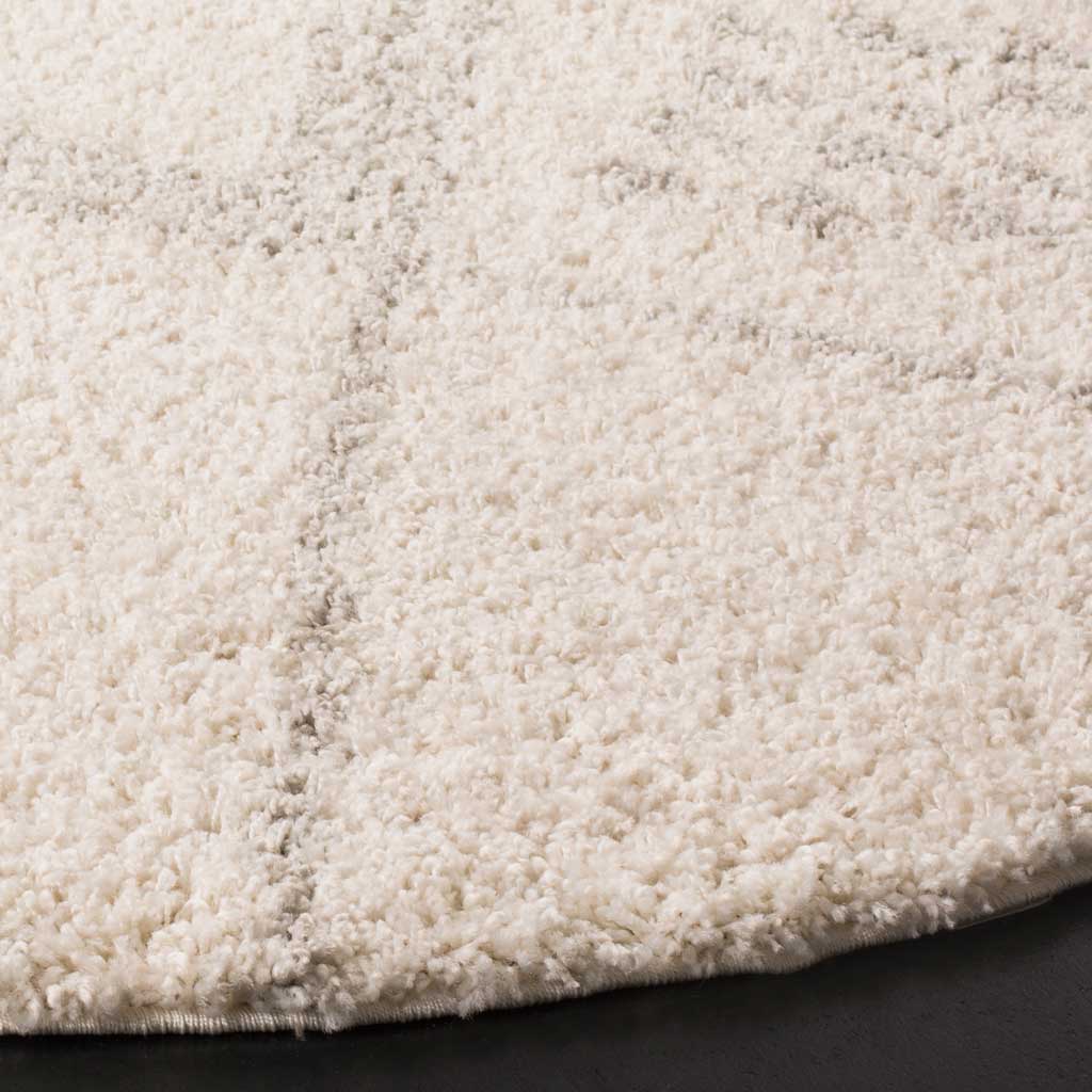 Creamy ivory shag pile contrasts with fine gray lines for subtle depth and texture