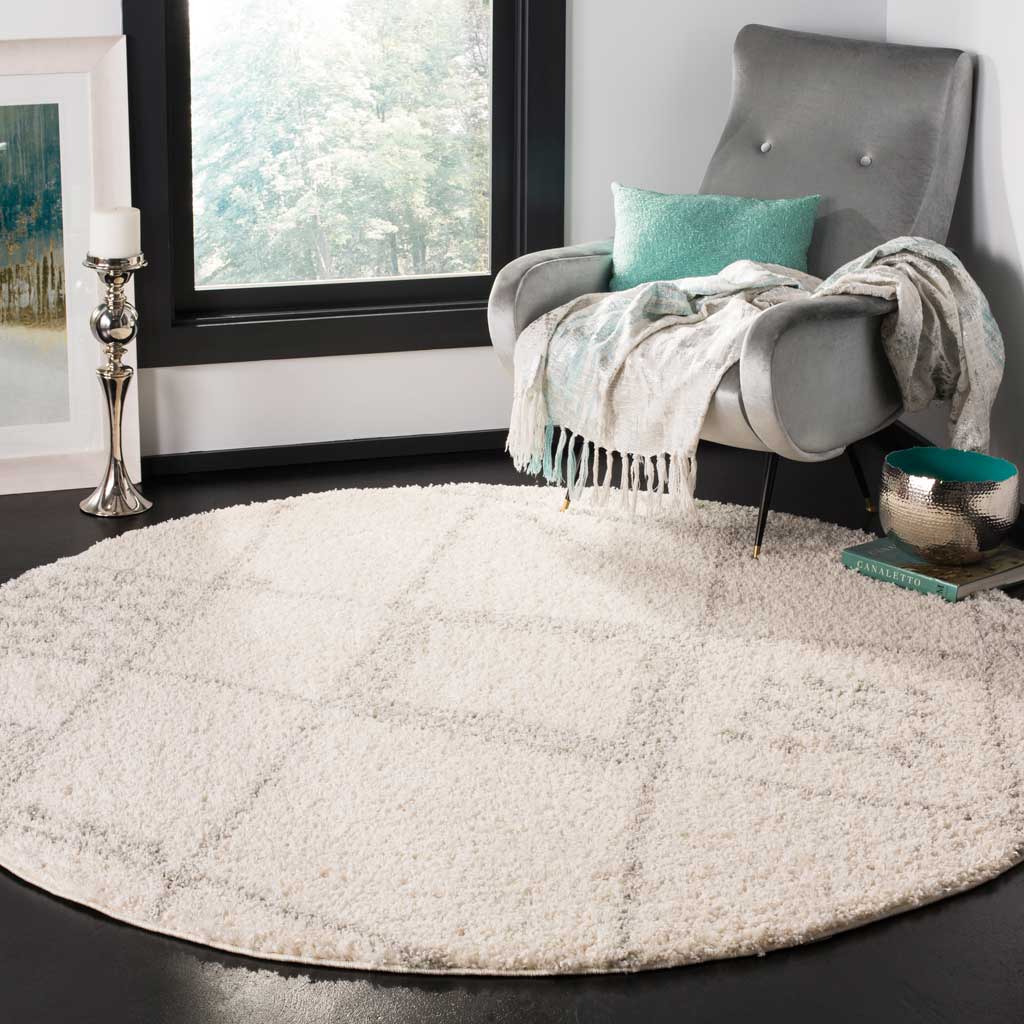 Ivory and gray geometric accents bring inviting texture to a cozy seating space