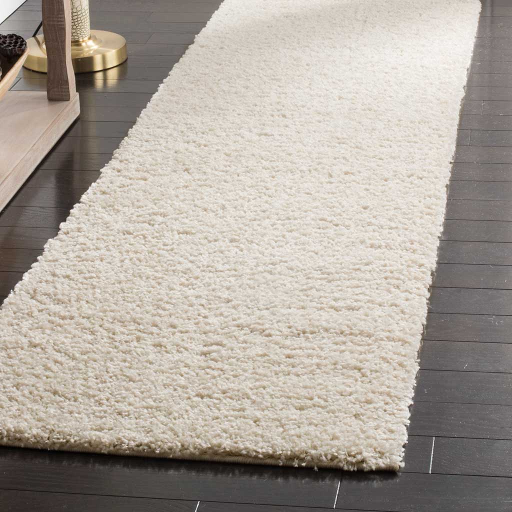 Deep cream shag pile gives this simple runner a cozy, cushioned look.