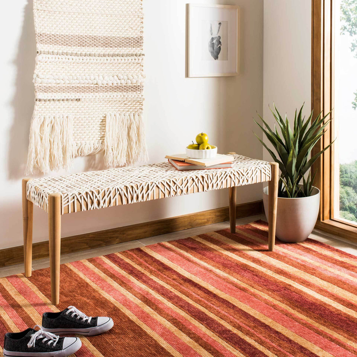 Off-white leather weaving and natural teak bring laid-back texture to a welcoming space.