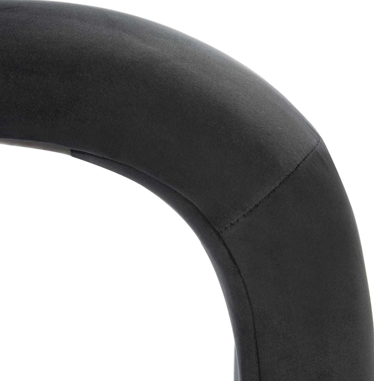 Tailored seams and smooth black velvet define the bench's sweeping curve.