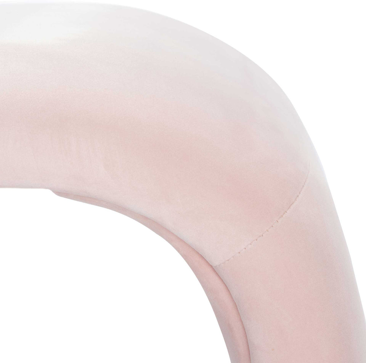 Subtle stitching follows the rounded bend of the soft pink velvet.