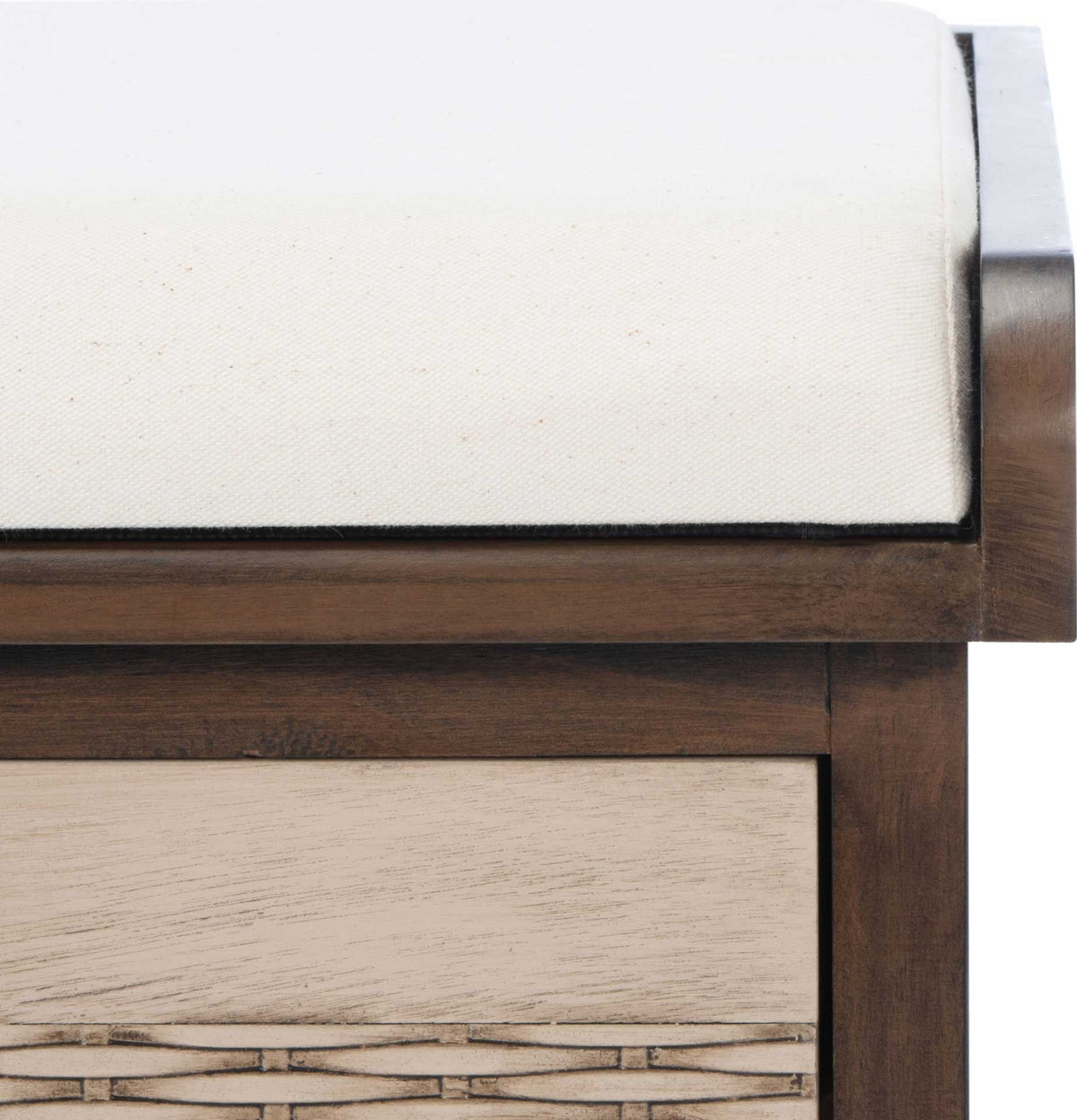 White cotton cushion meets warm brown wood above a subtly woven drawer front.
