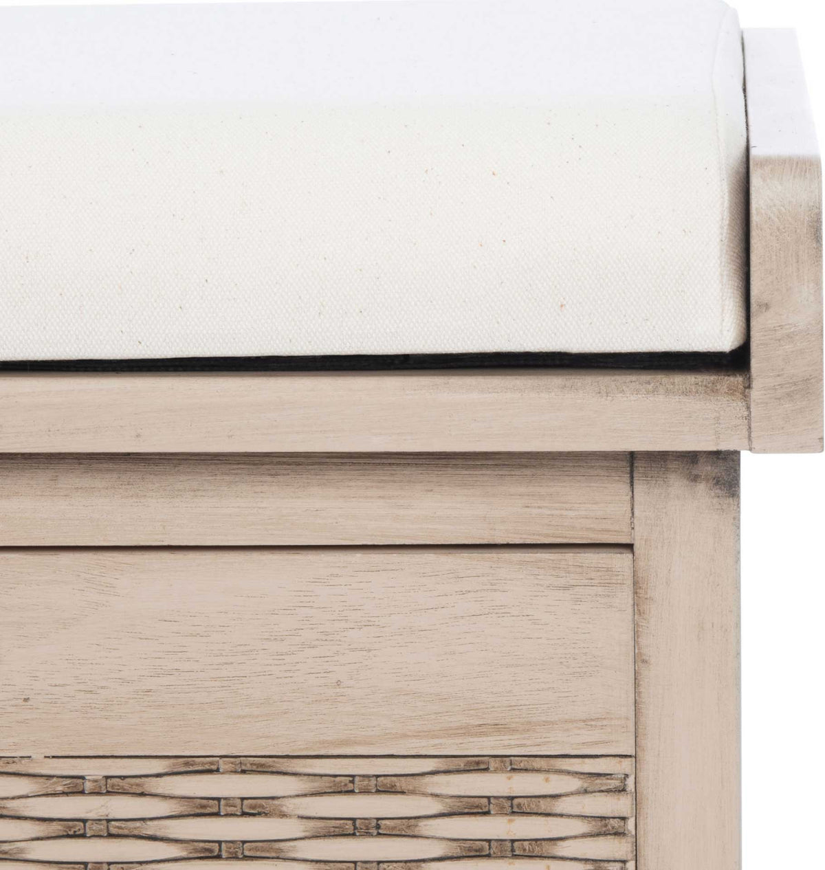 White upholstered padding meets a pale wood rail above the basket's natural weave.