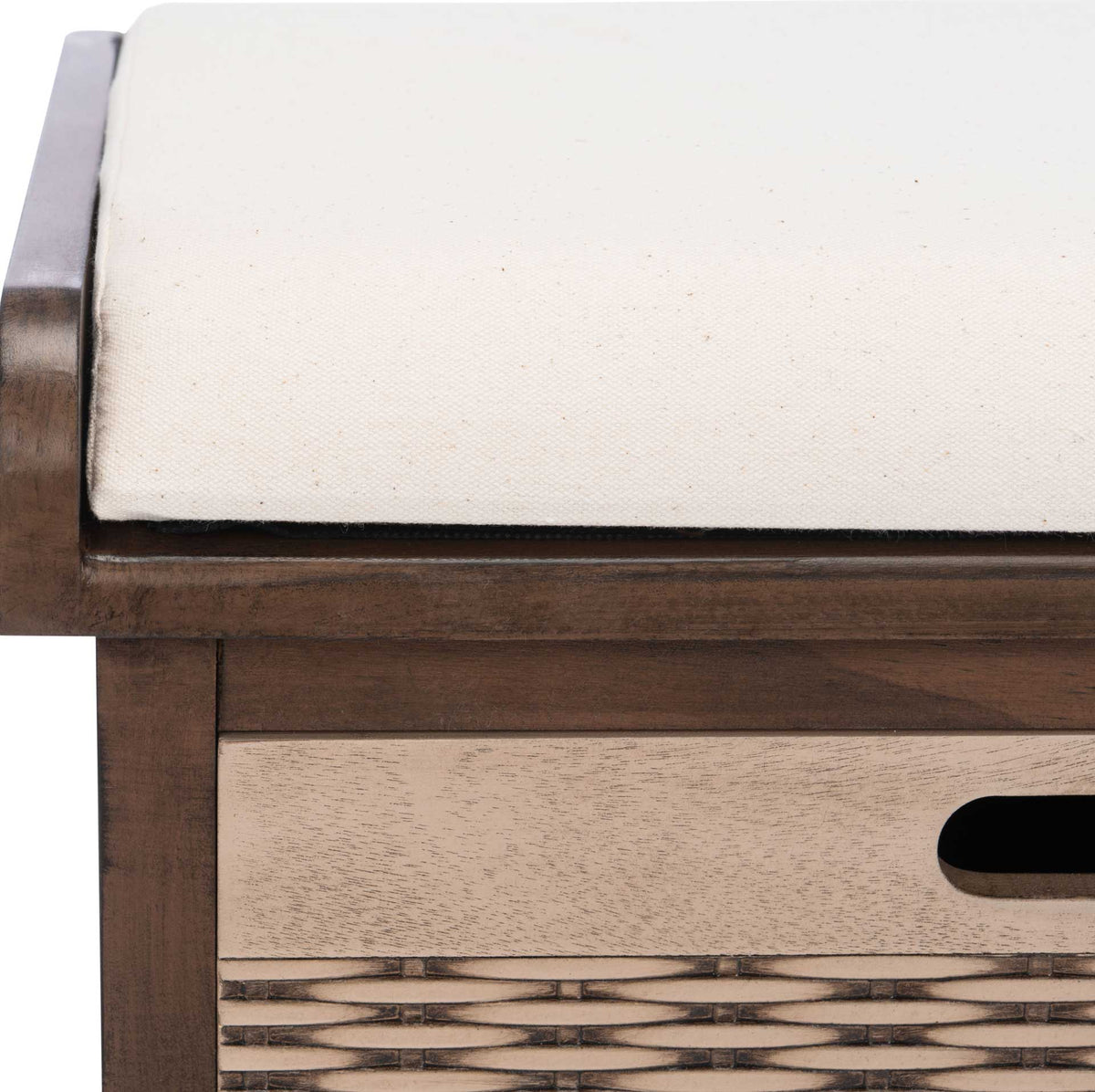 A crisp white cotton cushion rests in a brown wood frame above a woven drawer.