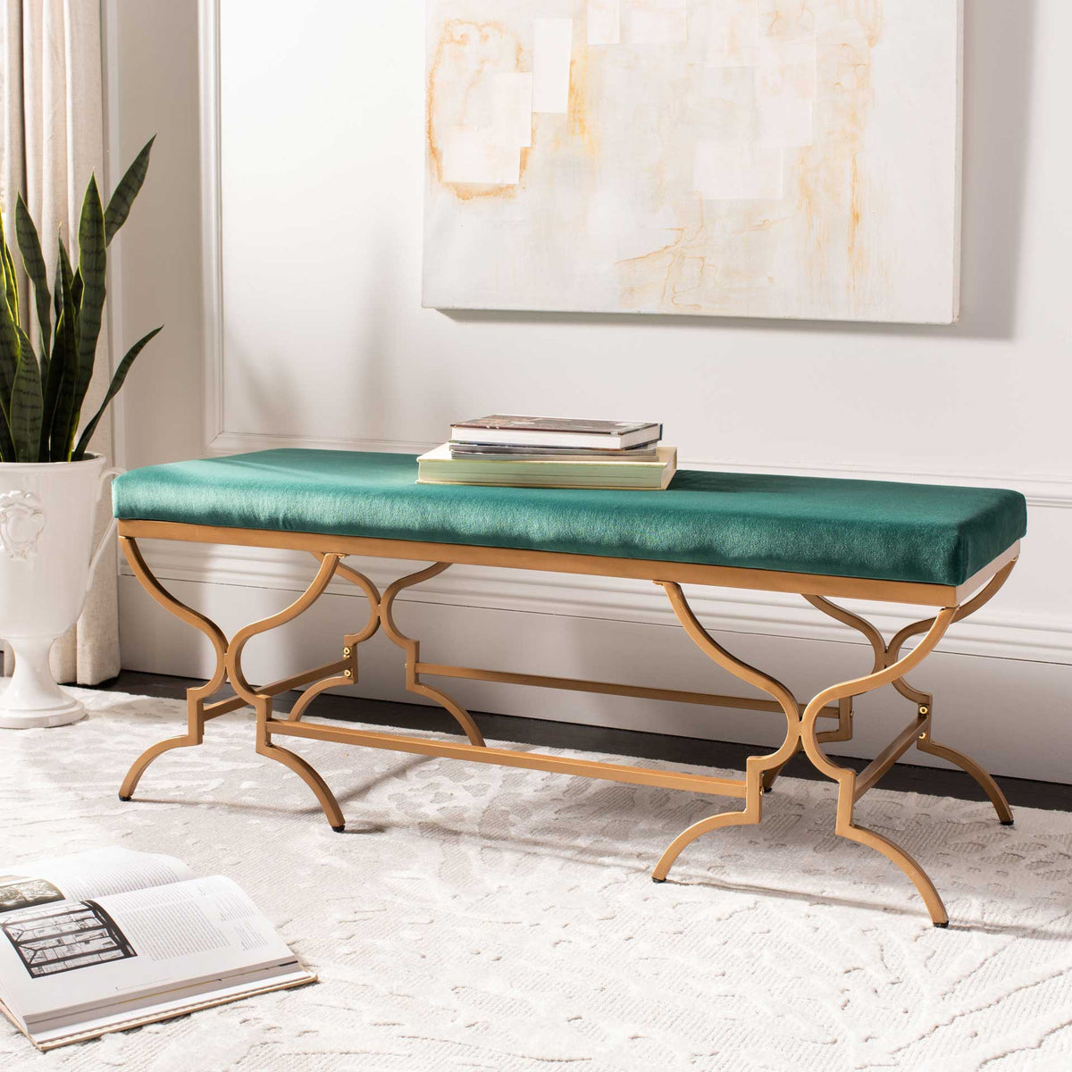 Emerald velvet seating and sculptural gold legs add a refined touch to a living space