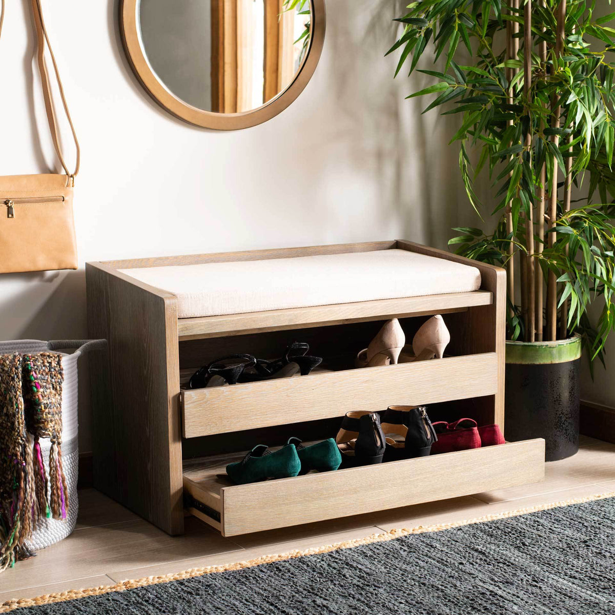 Slide-out drawers organize shoes beneath a beige cushioned seat in a warm wood frame.