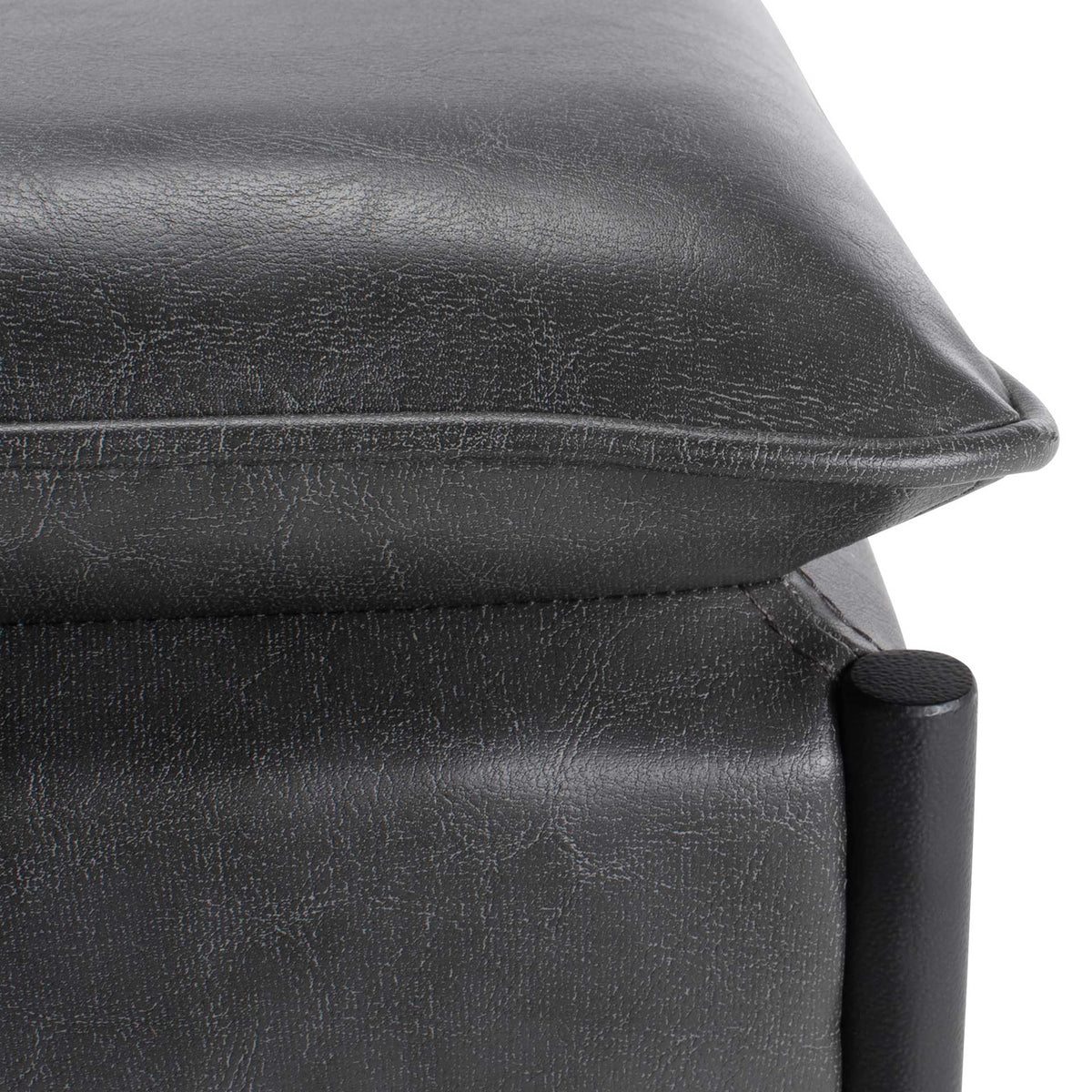Textured gray faux leather features a softly padded edge and neat piping