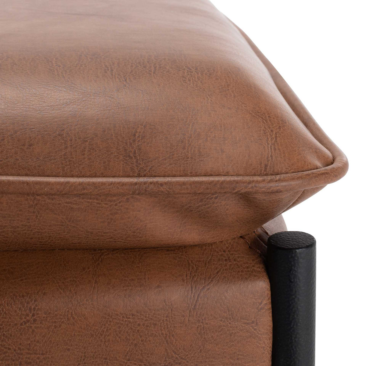 Brown faux leather seat reveals subtle grain, a padded edge and tailored piping