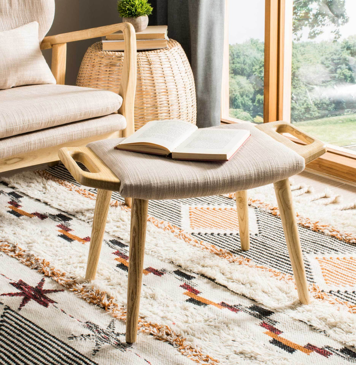 A compact beige bench adds soft seating and natural wood warmth beside a sunlit window.