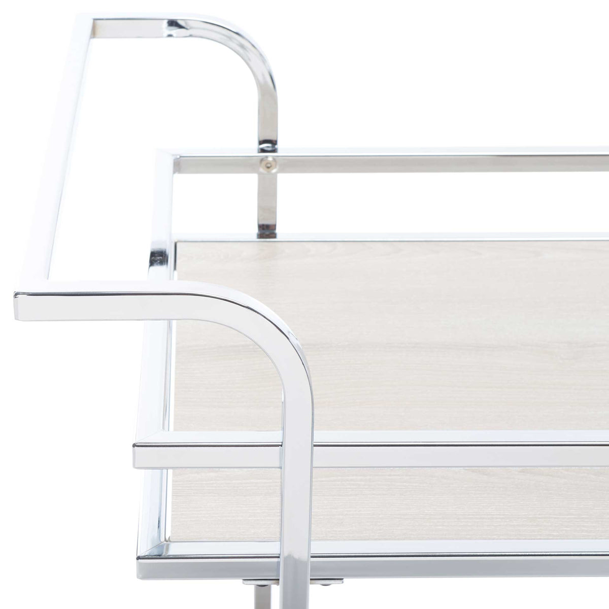 Sculpted chrome handles curve around a gray shelf framed by polished guardrails.