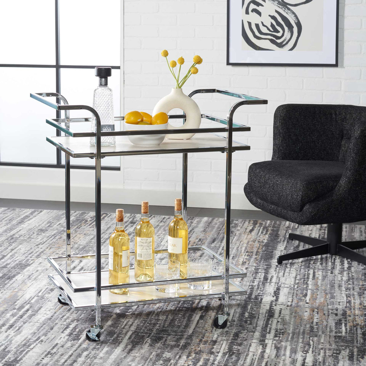 A gleaming chrome cart carries bottles and serveware on two gray shelves with raised rails.