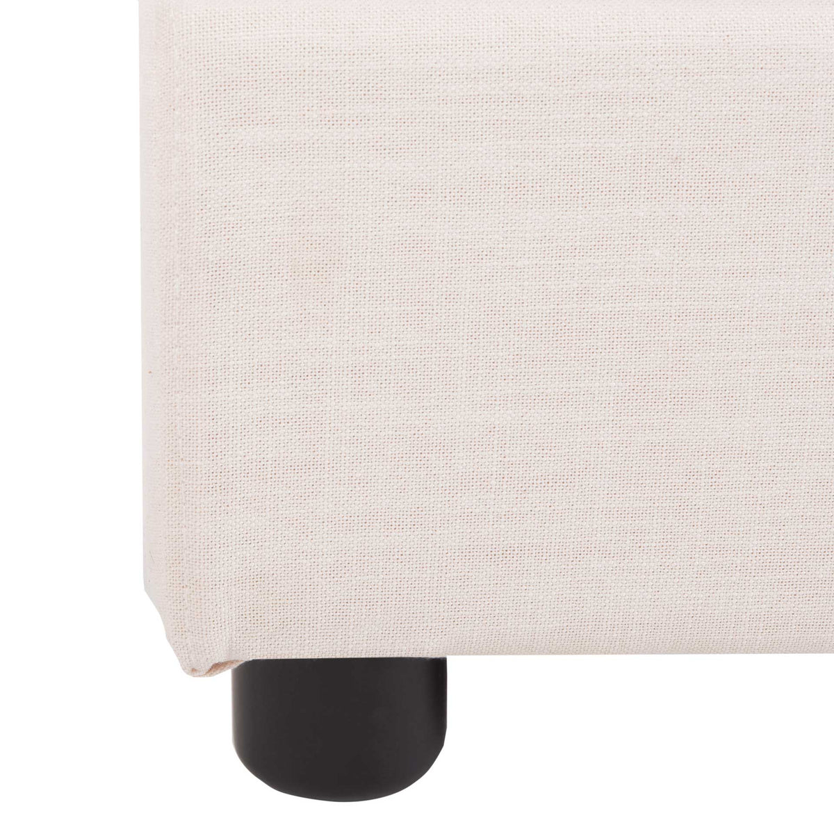 A rounded black foot supports the light beige upholstered bed frame