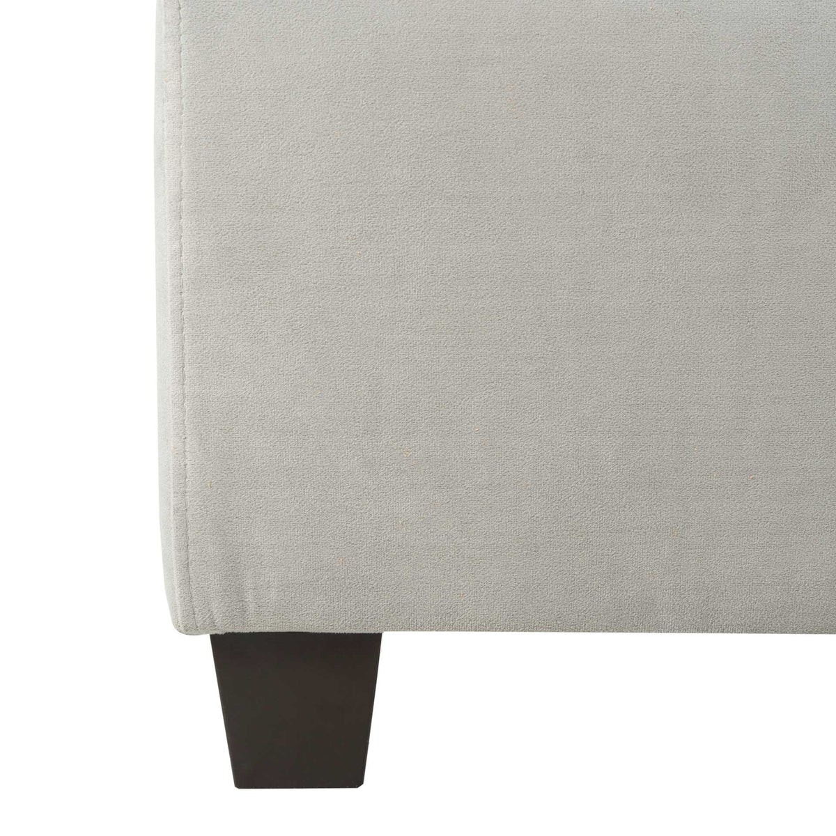 A dark tapered leg supports the tailored gray velvet bed frame
