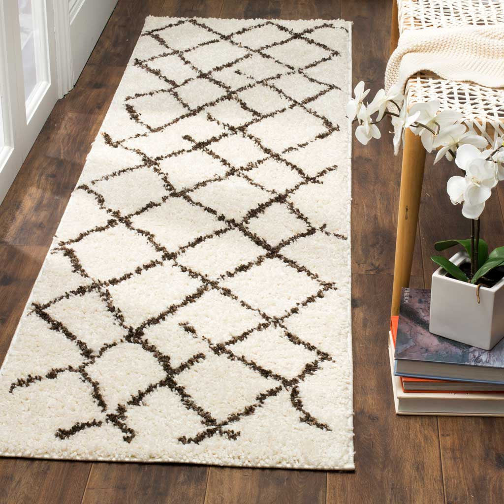 Cream shag runner pairs deep brown lattice lines with a soft pile for underfoot comfort