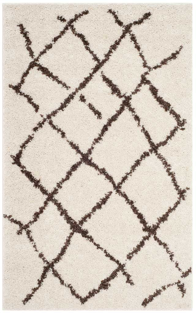 Cream shag rug with loosely sketched brown diamonds and a dense, cozy pile