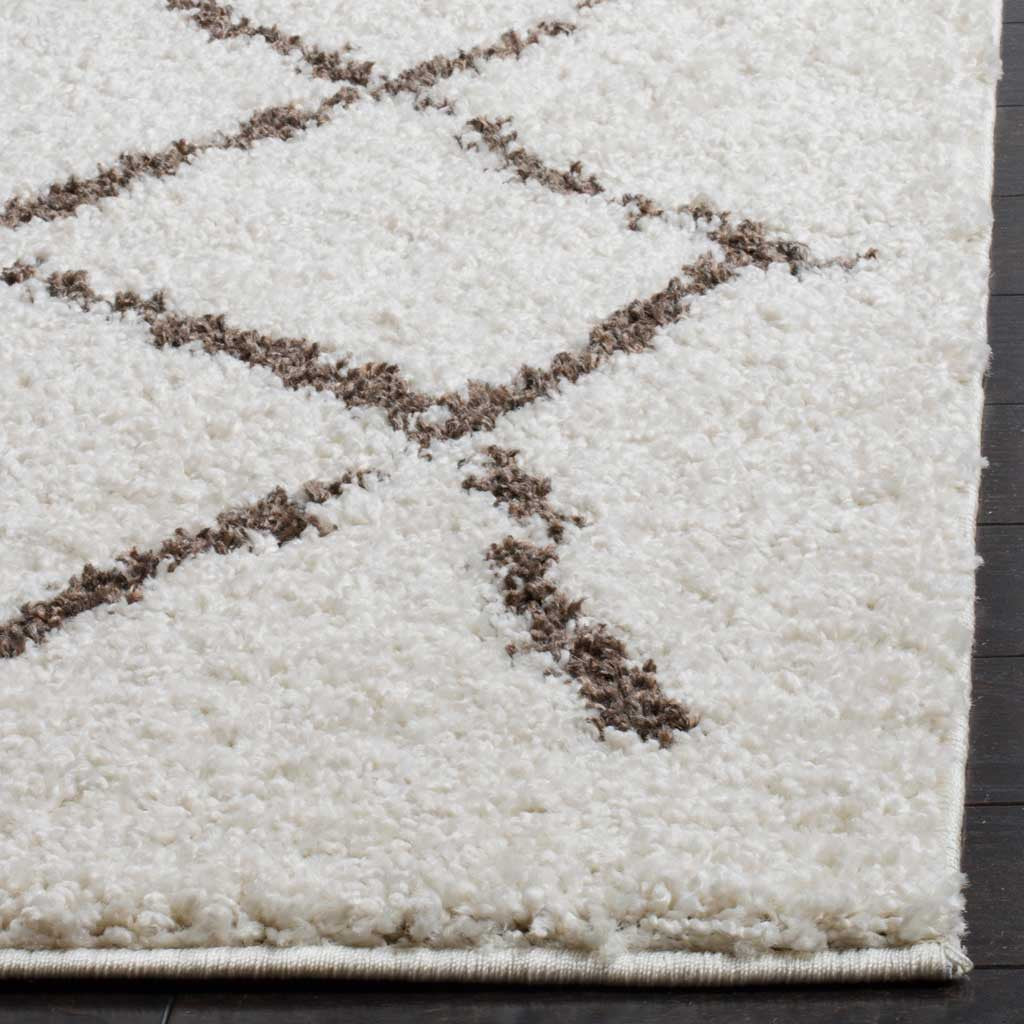 Plush cream fibers and broken brown lines meet a neatly bound edge