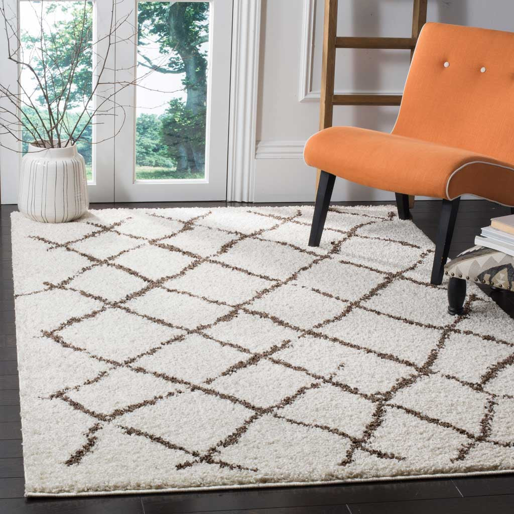 Cream shag with brown crisscross lines brings a cozy feel beneath an orange chair