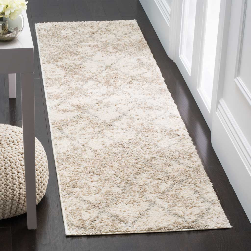 A plush cream runner softens the hallway with light gray accents and gentle patterning