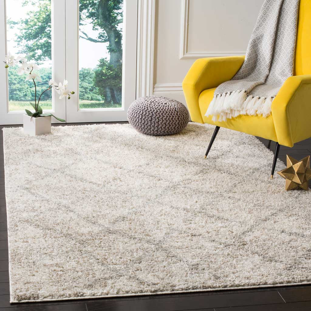 Cream and gray shag rug adds plush warmth beneath a vivid yellow accent chair