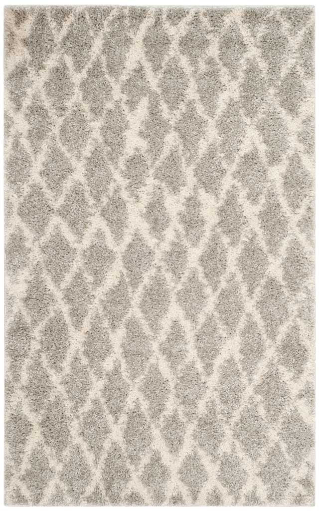Compact gray and cream shag rug features an airy diamond pattern and thick pile.
