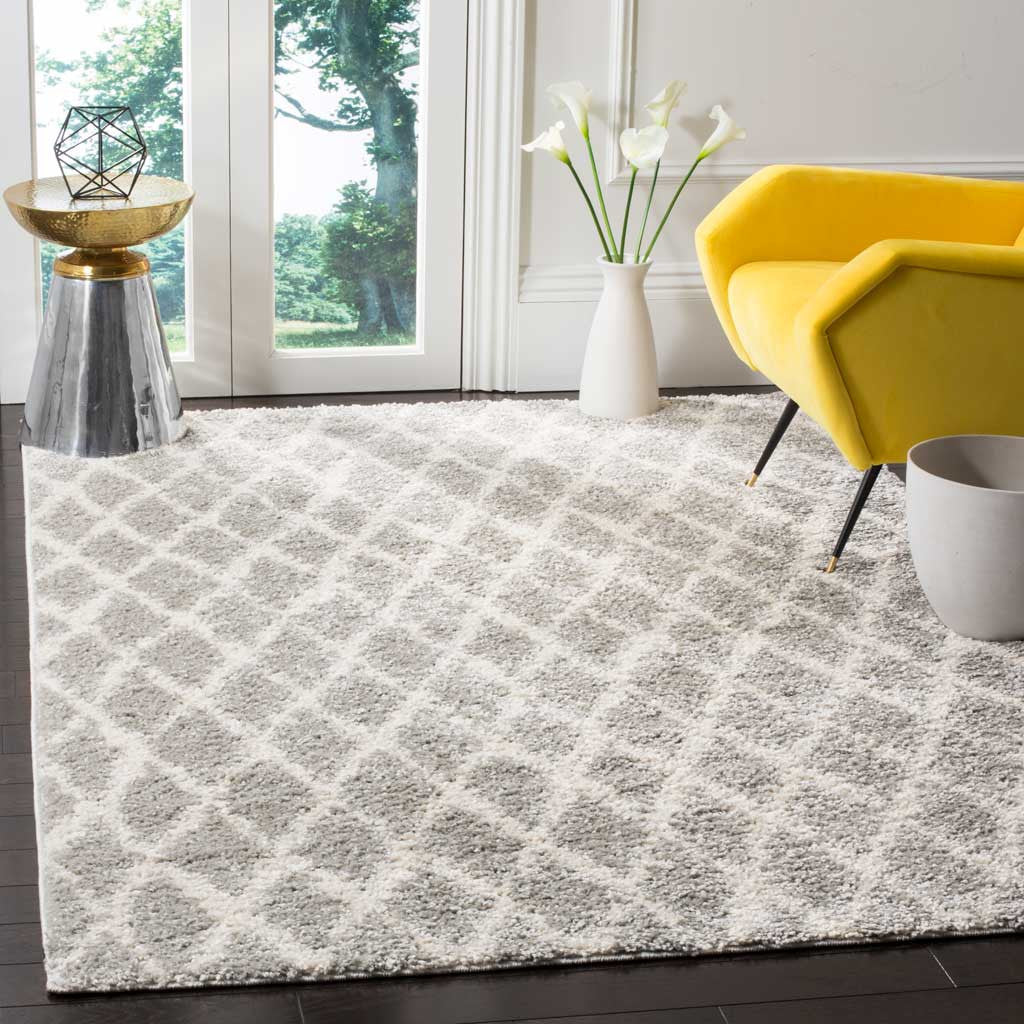 Plush gray and cream diamond-patterned shag adds warmth beneath a bright yellow chair.
