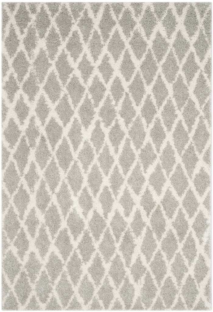 Soft gray shag and cream latticework give this rectangular rug a cozy geometric look.