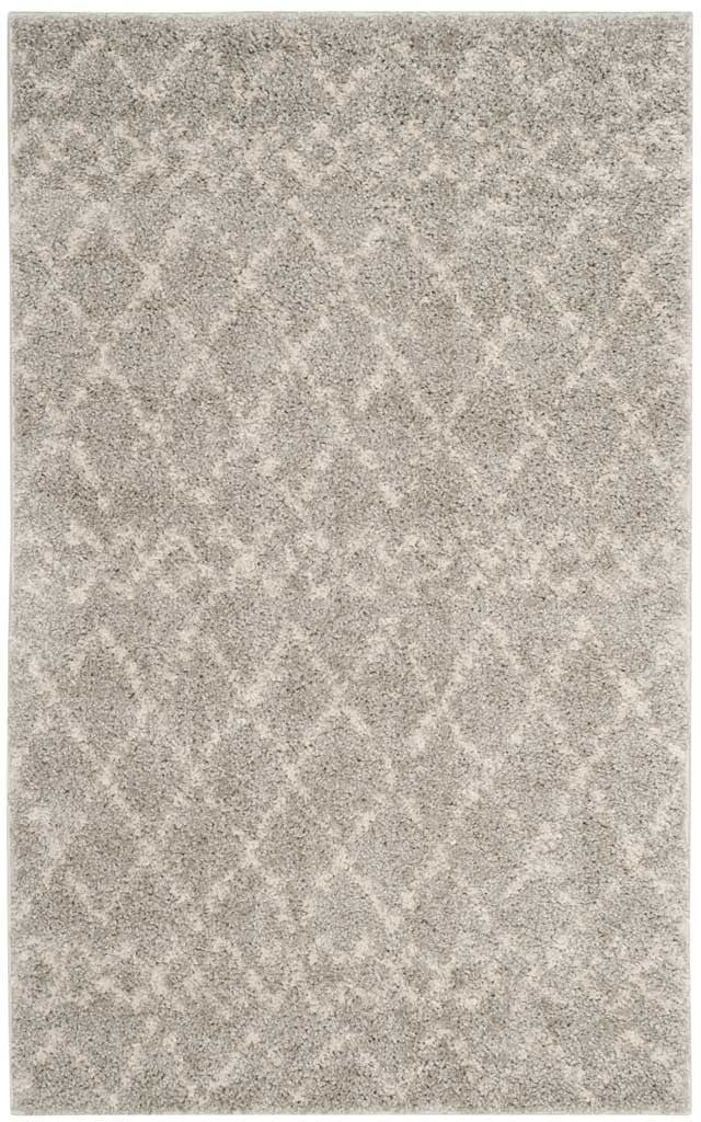 Soft rectangular shag rug has a cream diamond motif on a light gray ground