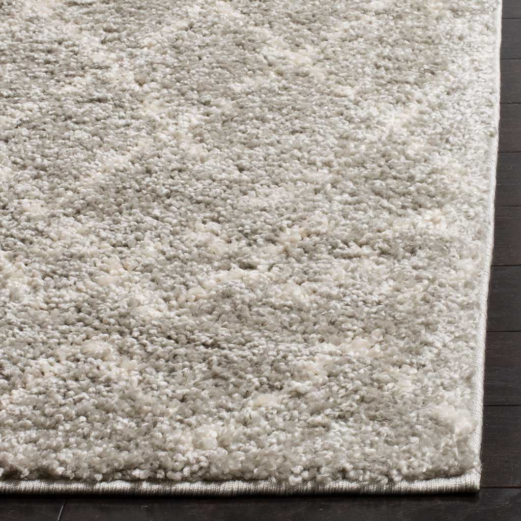 Deep cream and gray shag pile meets a neatly finished rug edge