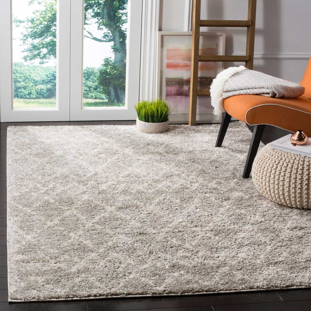 Plush light gray and cream shag rug brings cozy texture to a bright living space