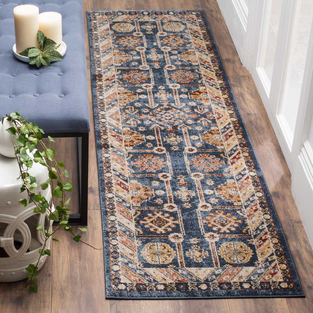 Rich blue runner rug with a symmetrical, rust-accented pattern and ivory border
