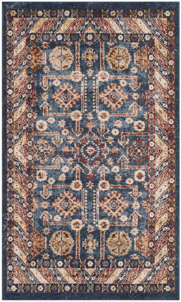Compact royal blue rug features mirrored ivory motifs, warm rust accents and a patterned border