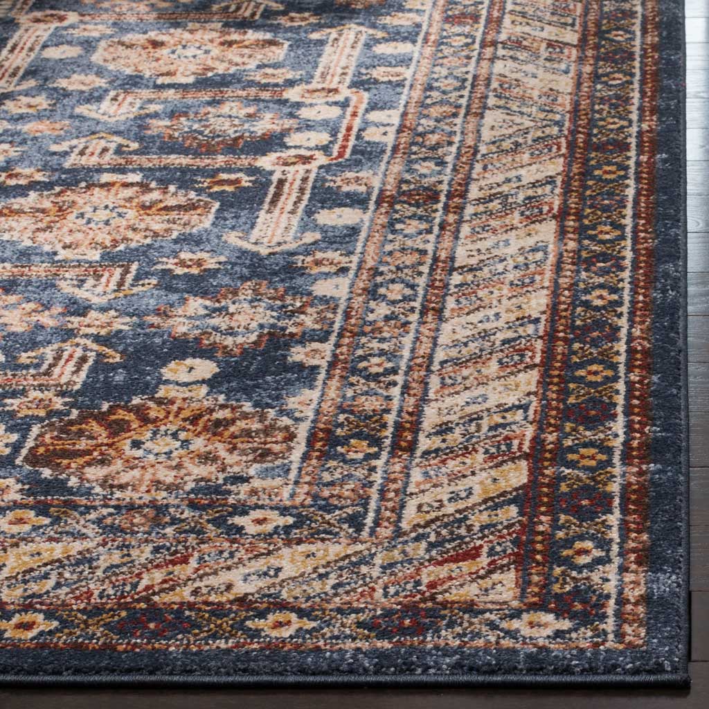 Ivory and rust motifs meet a geometric border and neatly bound edge on this royal blue rug