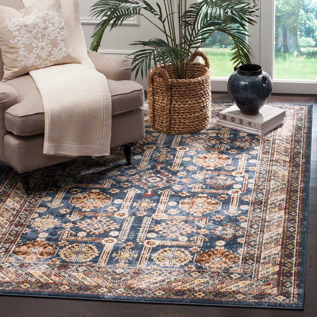 Royal blue rug brings ivory and rust medallions and an intricate border to a cozy living area