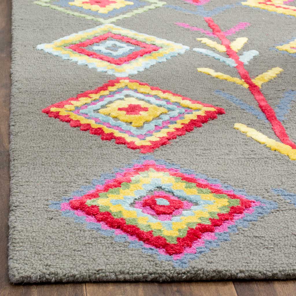 Raised diamonds in pink, yellow, and blue add vivid texture to the dense gray wool pile.