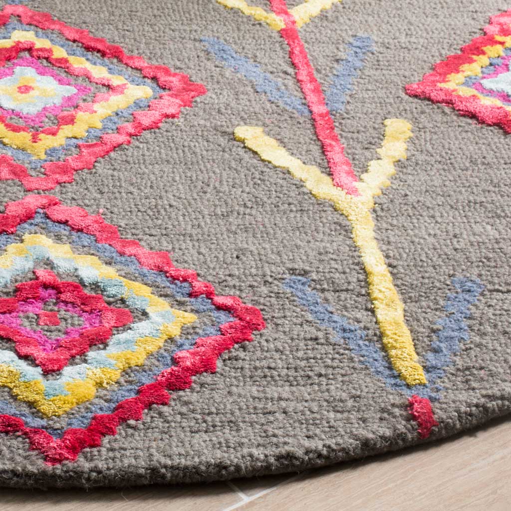 Raised pink and yellow tufting adds texture to colorful diamond motifs on gray wool